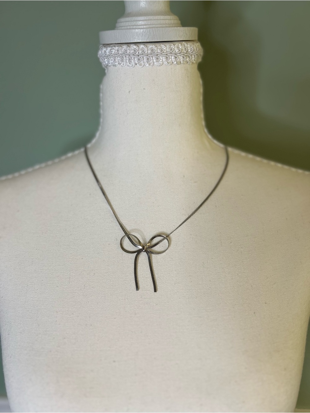 Delicate Bow Pendant Necklace in Silver tone With Lobster Claw Clasp.